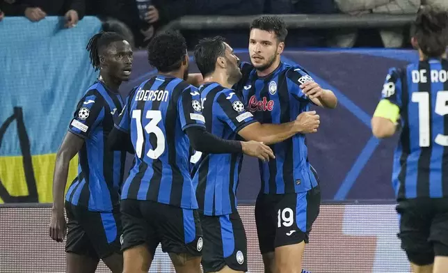 Atalanta's Berat Djimsiti celebrates with his teammates after scoring the opening goal during the Champions League opening phase soccer match between Shakhtar Donetsk and Atalanta at the Arena AufSchalke in Gelsenkirchen, Germany, Wednesday Oct. 2, 2024. (AP Photo/Martin Meissner)