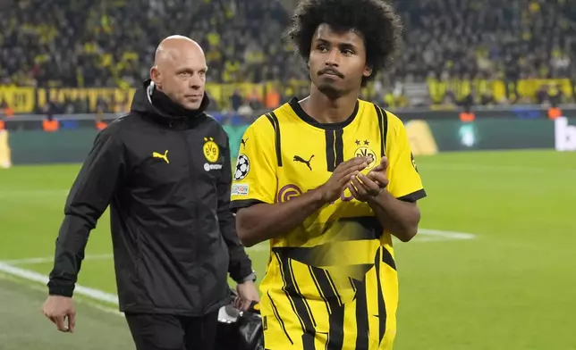 Dortmund's Karim Adeyemi applauds the fans as he leaves the pitch after an injuring during the Champions League opening phase soccer match between Borussia Dortmund and Celtic FC at the BVB Stadion in Dortmund, Germany, Tuesday, Oct. 1, 2024. (AP Photo/Martin Meissner)