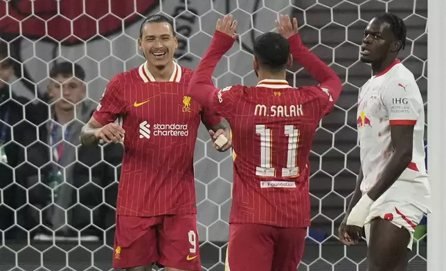 Liverpool's Darwin Nunez, left, celebrates with Liverpool's Mohamed Salah after scoring the opening goal during the Champions League opening phase soccer match between RB Leipzig and Liverpool at the RB Arena in Leipzig, Germany, Wednesday, Oct. 23, 2024.(AP Photo/Matthias Schrader)