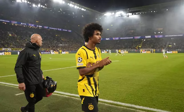 Dortmund's Karim Adeyemi applauds the fans as he leaves the pitch after an injuring during the Champions League opening phase soccer match between Borussia Dortmund and Celtic FC at the BVB Stadion in Dortmund, Germany, Tuesday, Oct. 1, 2024. (AP Photo/Martin Meissner)