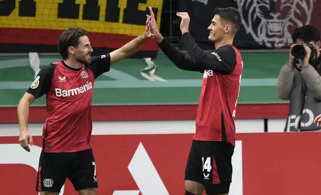 Leverkusen's scorer Patrik Schick, right, celebrates his opening goal with Leverkusen's Jonas Hofmann during the German Soccer Cup match between Bayer Leverkusen and SV Elversberg at the BayArena in Leverkusen, Germany, Tuesday, Oct. 29, 2024. (AP Photo/Martin Meissner)