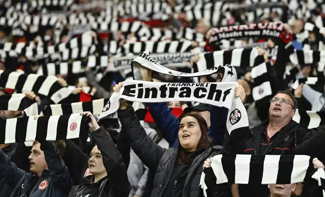 Fans of Eintracht Frankfurt hold up their fan scarves during the Europa League soccer match between Eintracht Frankfurt and FK Rigas Futbola Skola, in Frankfurt, Thursday, Oct. 24, 2024. (Uwe Anspach/dpa via AP)