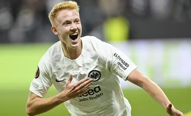 Frankfurt's Hugo Larsson celebrates after scoring their side's first goal of the game during the Europa League soccer match between Eintracht Frankfurt and FK Rigas Futbola Skola, in Frankfurt, Thursday, Oct. 24, 2024. (Uwe Anspach/dpa via AP)