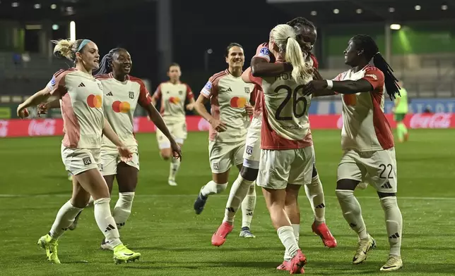 Lyon's Lindsey Horan celebrates with teammates after scoring their side's second goal of the game during the Women's Champions League group stage soccer match between VfL Wolfsburg and Olympique Lyon at the AOK Stadion in Wolfsburg, Germany, Thursday Oct. 17, 2024. (Swen Pförtner/dpa via AP)