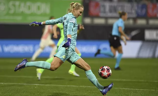 Wolfsburg's Merle Frohms shoots the ball during the Women's Champions League group stage soccer match between VfL Wolfsburg and Olympique Lyon, at AOK Stadion in Wolfsburg, Germany, Thursday Oct. 17, 2024. (Swen Pförtner/dpa via AP)