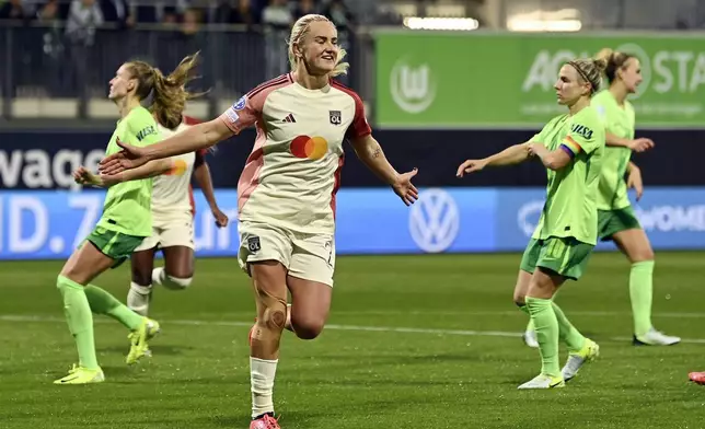 Lyon's Lindsey Horan celebrates after scoring a goal during the Women's Champions League group stage soccer match between VfL Wolfsburg and Olympique Lyon, at the AOK Stadion in Wolfsburg, Germany, Thursday Oct. 17, 2024. (Swen Pförtner/dpa via AP)