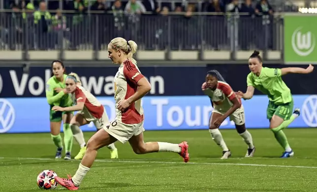 Lyon's Lindsey Horan scores from the penalty spot during the Women's Champions League group stage soccer match between VfL Wolfsburg and Olympique Lyon at the AOK Stadion in Wolfsburg, Germany, Thursday Oct. 17, 2024. (Swen Pförtner/dpa via AP)