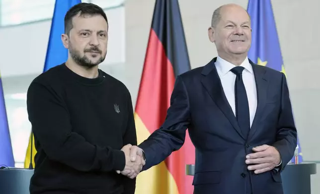 Ukraine's president Volodymyr Zelenskyy and German chancellor Olaf Scholz shake hands at the chancellery in Berlin, Germany, Friday, Oct. 11, 2024. (AP Photo/Ebrahim Noroozi)