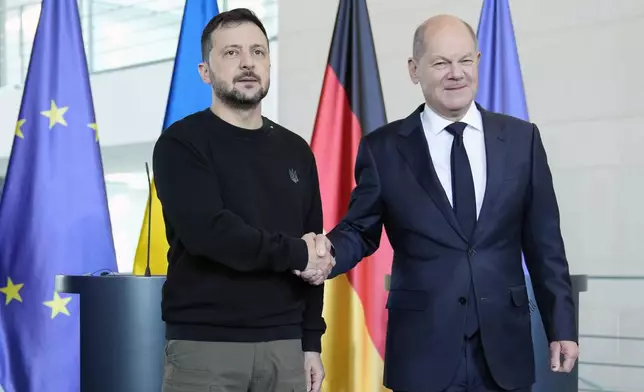 Ukraine's president Volodymyr Zelenskyy and German chancellor Olaf Scholz shake hands at the chancellery in Berlin, Germany, Friday, Oct. 11, 2024. (AP Photo/Ebrahim Noroozi)