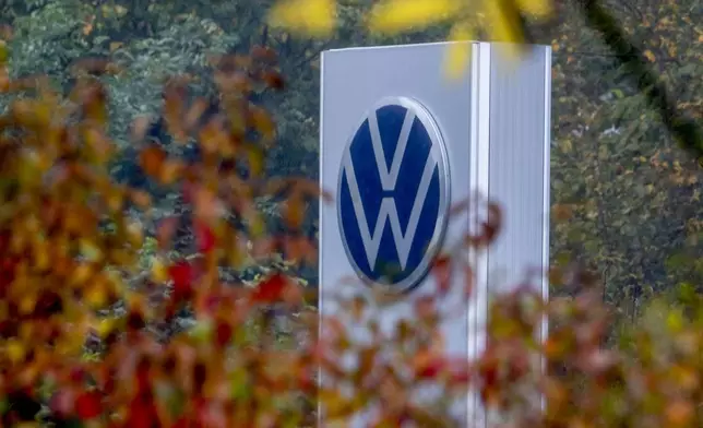 A Volkswagen logo of a car dealer is pictured in Neu-Anspach near Frankfurt, Germany, Wednesday, Oct. 30, 2024. (AP Photo/Michael Probst)