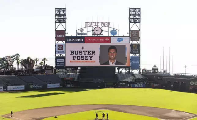 A photograph of San Francisco Giants President of Baseball Operations Buster Posey is seen on the Jumbotron at Oracle Park ahead of his introductory press conference in San Francisco, Tuesday, Oct. 1, 2024. (Stephen Lam/San Francisco Chronicle via AP)