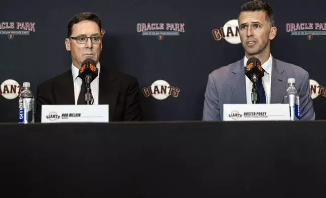 San Francisco Giants new president of baseball operations Buster Posey, right, speaks next to manager Bob Melvin during a news conference in San Francisco, Tuesday, Oct. 1, 2024. (Stephen Lam/San Francisco Chronicle via AP)