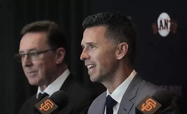 San Francisco Giants new president of baseball operations Buster Posey, right, speaks next to manager Bob Melvin during a news conference in San Francisco, Tuesday, Oct. 1, 2024. (AP Photo/Jeff Chiu)