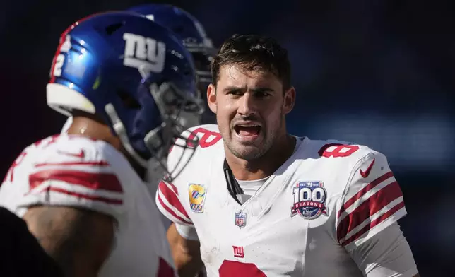 New York Giants quarterback Daniel Jones (8) celebrates after throwing a 30-yard touchdown pass during the second half of an NFL football game against the Seattle Seahawks, Sunday, Oct. 6, 2024, in Seattle. (AP Photo/Lindsey Wasson)