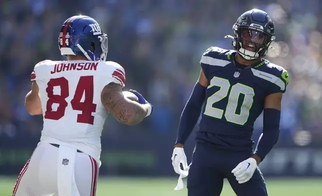 Seattle Seahawks safety Julian Love (20) reacts after tackling New York Giants tight end Theo Johnson (84) during the first half of an NFL football game, Sunday, Oct. 6, 2024, in Seattle. (AP Photo/Lindsey Wasson)