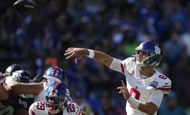 New York Giants quarterback Daniel Jones (8) passes during the first half of an NFL football game against the Seattle Seahawks, Sunday, Oct. 6, 2024, in Seattle. (AP Photo/Lindsey Wasson)