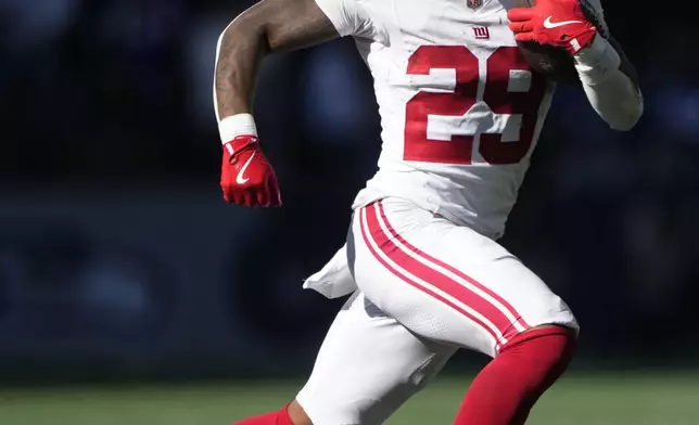 New York Giants running back Tyrone Tracy Jr. (29) runs with the football during the first half of an NFL football game against the Seattle Seahawks, Sunday, Oct. 6, 2024, in Seattle. (AP Photo/Lindsey Wasson)