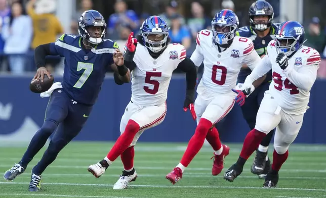 Seattle Seahawks quarterback Geno Smith (7) runs with the football as New York Giants linebacker Kayvon Thibodeaux (5) pressures during the second half of an NFL football game, Sunday, Oct. 6, 2024, in Seattle. (AP Photo/Lindsey Wasson)