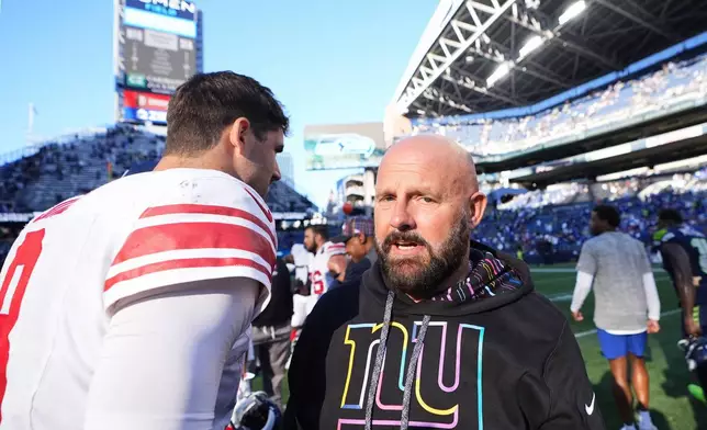 New York Giants quarterback Daniel Jones (8) and head coach Brian Daboll stand on the field after an NFL football game against the Seattle Seahawks, Sunday, Oct. 6, 2024, in Seattle. The Giants won 29-20. (AP Photo/Linsey Wasson)