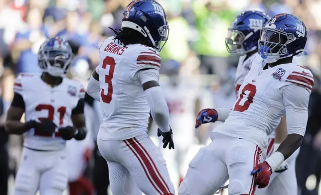 New York Giants linebacker Brian Burns (0) celebrates after sacking Seattle Seahawks quarterback Geno Smith (7) during the second half of an NFL football game, Sunday, Oct. 6, 2024, in Seattle. (AP Photo/John Froschauer)