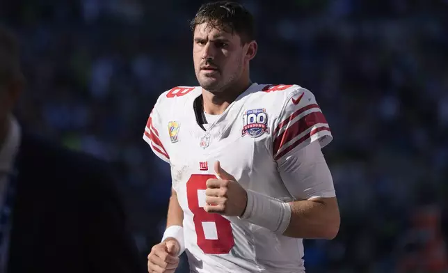 New York Giants quarterback Daniel Jones (8) jogs off the field at halftime of an NFL football game against the Seattle Seahawks, Sunday, Oct. 6, 2024, in Seattle. (AP Photo/Lindsey Wasson)