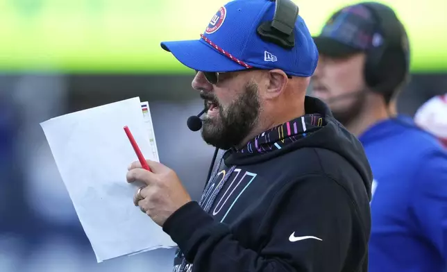 New York Giants head coach Brian Daboll looks at a play sheet during the second half of an NFL football game against the Seattle Seahawks, Sunday, Oct. 6, 2024, in Seattle. (AP Photo/Lindsey Wasson)