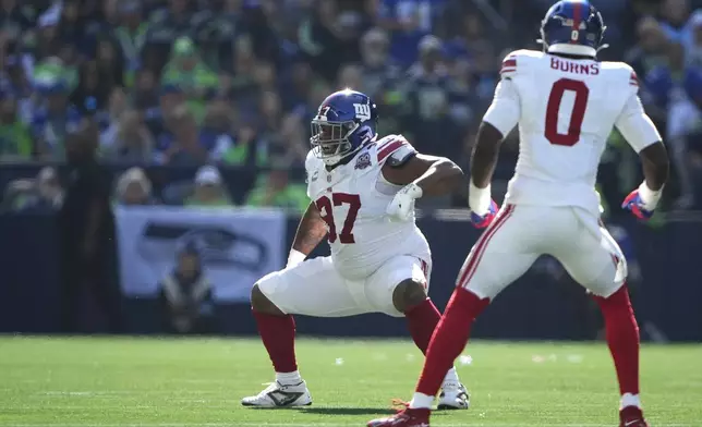 New York Giants defensive tackle Dexter Lawrence II (97) celebrates after sacking Seattle Seahawks quarterback Geno Smith (7) during the first half of an NFL football game, Sunday, Oct. 6, 2024, in Seattle. (AP Photo/Lindsey Wasson)