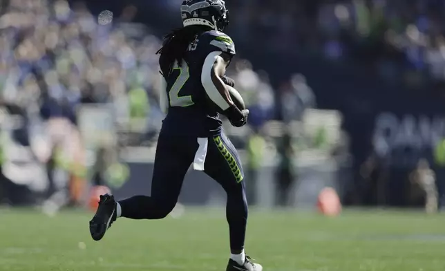 Seattle Seahawks safety Rayshawn Jenkins (2) runs for a 102-yard touchdown after recovering a fumble during the first half of an NFL football game agains the New York Giants, Sunday, Oct. 6, 2024, in Seattle. (AP Photo/John Froschauer)