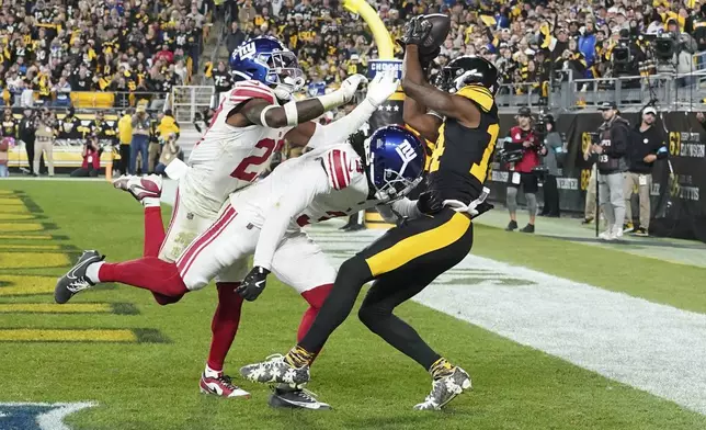 Pittsburgh Steelers wide receiver George Pickens, right, makes a catch in the end zone, which was ruled incomplete upon review, during the first half of an NFL football game against the New York Giants, Monday, Oct. 28, 2024, in Pittsburgh. (AP Photo/Matt Freed)