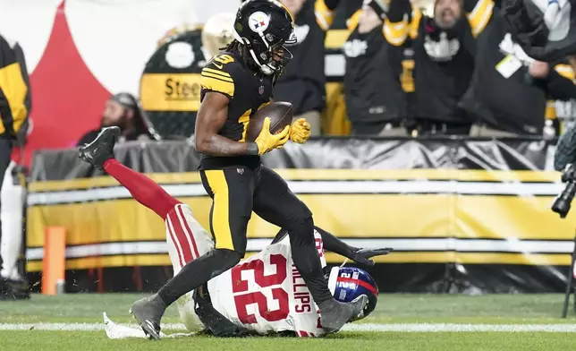 Pittsburgh Steelers wide receiver Calvin Austin III catches a touchdown over New York Giants cornerback Dru Phillips (22) during the second half of an NFL football game Monday, Oct. 28, 2024, in Pittsburgh. (AP Photo/Matt Freed)