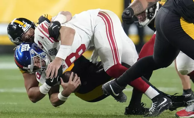 New York Giants quarterback Daniel Jones (8) is sacked by Pittsburgh Steelers linebacker Alex Highsmith during the second half of an NFL football game Monday, Oct. 28, 2024, in Pittsburgh. (AP Photo/Gene J. Puskar)