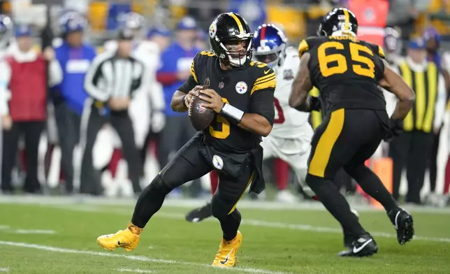 Pittsburgh Steelers quarterback Russell Wilson (3) rolls out during the first half of an NFL football game against the New York Giants, Monday, Oct. 28, 2024, in Pittsburgh. (AP Photo/Gene J. Puskar)