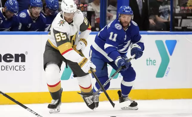 Vegas Golden Knights right wing Keegan Kolesar (55) steals the puck from Tampa Bay Lightning center Luke Glendening (11) during the first period of an NHL hockey game Thursday, Oct. 17, 2024, in Tampa, Fla. (AP Photo/Chris O'Meara)