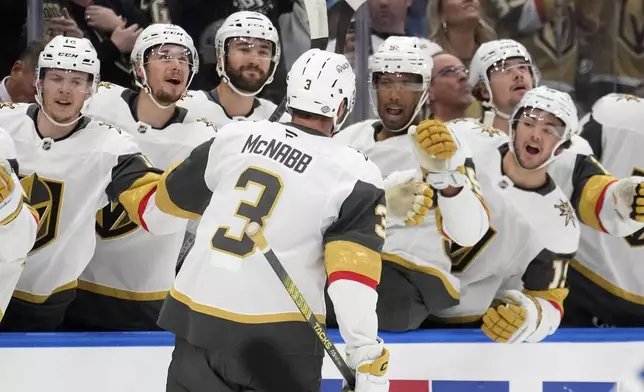 Vegas Golden Knights defenseman Brayden McNabb (3) celebrates with the bench after his goal against the Tampa Bay Lightning during the first period of an NHL hockey game Thursday, Oct. 17, 2024, in Tampa, Fla. (AP Photo/Chris O'Meara)