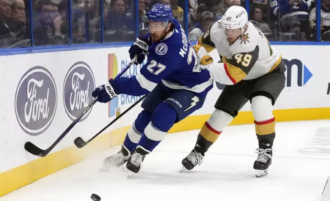 Tampa Bay Lightning defenseman Ryan McDonagh (27) gets ahead of Vegas Golden Knights center Ivan Barbashev (49) during the first period of an NHL hockey game Thursday, Oct. 17, 2024, in Tampa, Fla. (AP Photo/Chris O'Meara)