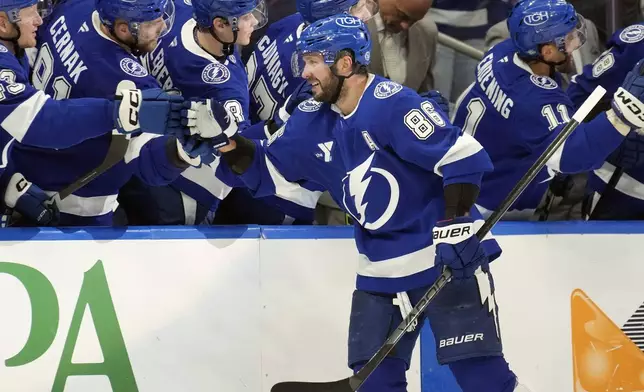 Tampa Bay Lightning right wing Nikita Kucherov (86) celebrates with the bench after scoring against the Vegas Golden Knights during the third period of an NHL hockey game Thursday, Oct. 17, 2024, in Tampa, Fla. (AP Photo/Chris O'Meara)