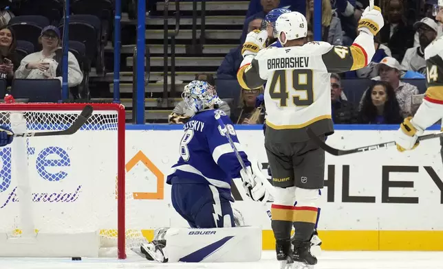 Vegas Golden Knights center Ivan Barbashev (49) celebrates after scoring past Tampa Bay Lightning goaltender Andrei Vasilevskiy (88) during the second period of an NHL hockey game Thursday, Oct. 17, 2024, in Tampa, Fla. (AP Photo/Chris O'Meara)