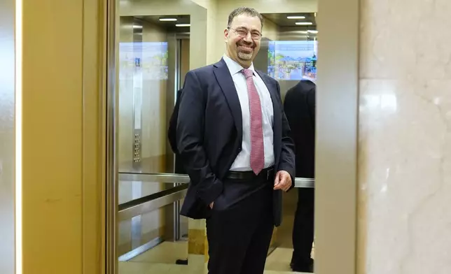 Economist Daron Acemoglu, 2024 Nobel prize winner in Economics, stands in an elevator after speaking to the media during a conference in Athens, Greece, Monday, Oct. 14, 2024. (AP Photo/Petros Giannakouris)