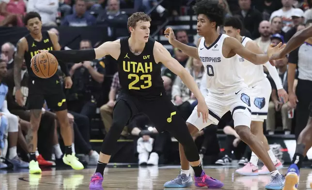 Utah Jazz forward Lauri Markkanen (23) looks to drive against Memphis Grizzlies forward Jaylen Wells (0) during the first half of an NBA basketball game, Wednesday, Oct. 23, 2024, in Salt Lake City. (AP Photo/Rob Gray)