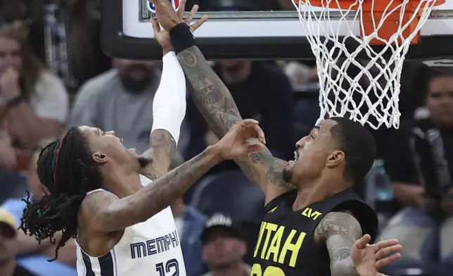 Memphis Grizzlies guard Ja Morant (12) lays the ball up against Utah Jazz forward John Collins (20) during the second half of an NBA basketball game, Wednesday, Oct. 23, 2024, in Salt Lake City. (AP Photo/Rob Gray)