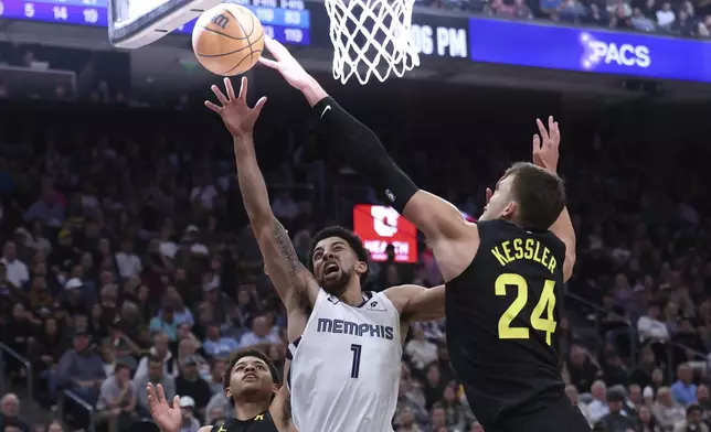 Utah Jazz center Walker Kessler (24) blocks the shot of Memphis Grizzlies guard Scotty Pippen Jr. (1) during the first half of an NBA basketball game, Wednesday, Oct. 23, 2024, in Salt Lake City. (AP Photo/Rob Gray)