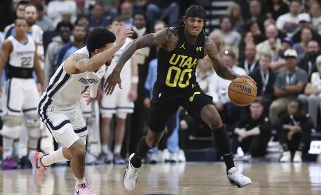 Utah Jazz guard Jordan Clarkson (00) brings the ball up the court against Memphis Grizzlies guard Scotty Pippen Jr. (1) during the second half of an NBA basketball game, Wednesday, Oct. 23, 2024, in Salt Lake City. (AP Photo/Rob Gray)