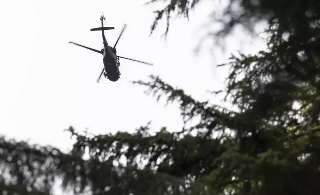 A U.S. Army helicopter continues searching for two missing aviators on Thursday, Oct. 17, 2024, near Goose Prairie, Yakima County, Wash., as the search continues for two fighter pilots whose EA-18G Growler jet crashed east of Mount Rainier. (Nick Wagner/The Seattle Times via AP)