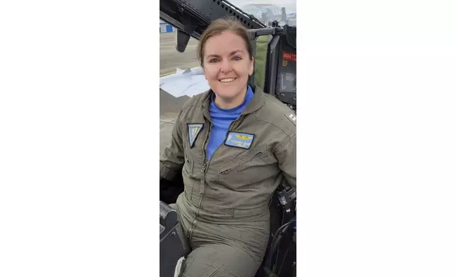 In this undated photo released by the U.S. Navy, Lt. Commander Lyndsay Evans, a Naval Flight Officer, sits in a cockpit. (U.S. Navy via AP)