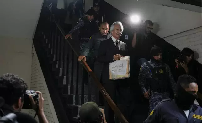 Guatemalan journalist Jose Ruben Zamora, founder of El Periodico newspaper, jailed for more than two years on money laundering charges, exits a courthouse after a judge granted him house arrest, in Guatemala City, Friday, Oct. 18, 2024. (AP Photo/Moises Castillo)