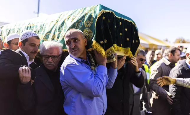 Mourners carry the casket of Fethullah Gülen, an influential Turkish spiritual leader and Islamic scholar who died this week in self-exile in the United States, at a funeral prayer service, Thursday, Oct, 24, 2024, in Augusta, N.J. (AP Photo/Eduardo Munoz Alvarez)