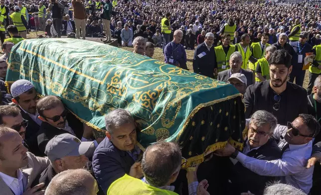 Mourners carry the casket of Fethullah Gülen, an influential Turkish spiritual leader and Islamic scholar who died this week in self-exile in the United States, at a funeral prayer service, Thursday, Oct, 24, 2024, in Augusta, N.J. (AP Photo/Eduardo Munoz Alvarez)