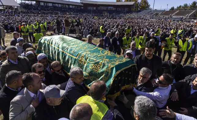 Mourners carry the casket of Fethullah Gülen, an influential Turkish spiritual leader and Islamic scholar who died this week in self-exile in the United States, at a funeral prayer service, Thursday, Oct, 24, 2024, in Augusta, N.J. (AP Photo/Eduardo Munoz Alvarez)