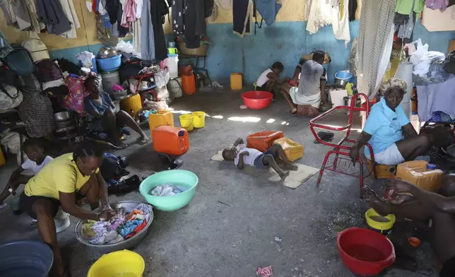 Families displaced by gang violence do laundry inside a school where they have been taking refuge for over a year in Port-au-Prince, Haiti, Friday, Sept. 20, 2024. (AP Photo/Odelyn Joseph)