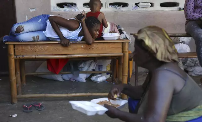 People displaced by armed gang attacks rest at the Antoinette Dessalines National School, a makeshift shelter, in Saint-Marc, Haiti, Sunday, Oct. 6, 2024. (AP Photo/Odelyn Joseph)